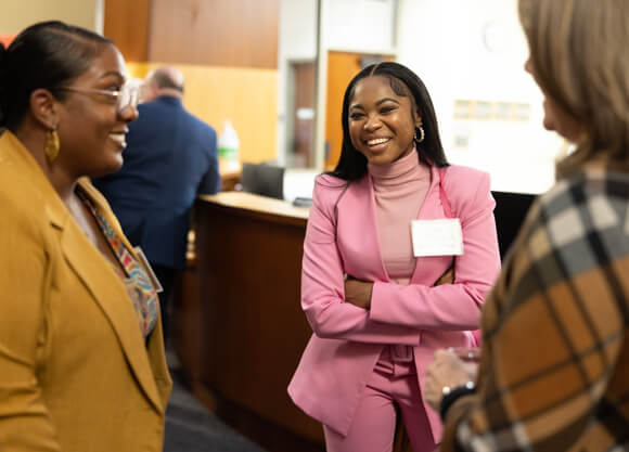 Students having a discussion in professional attire.