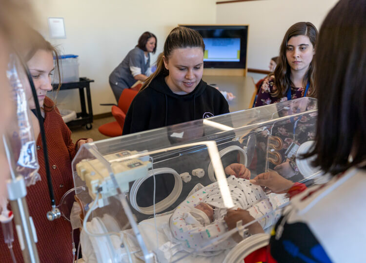 Physical therapy students work with patients and faculty