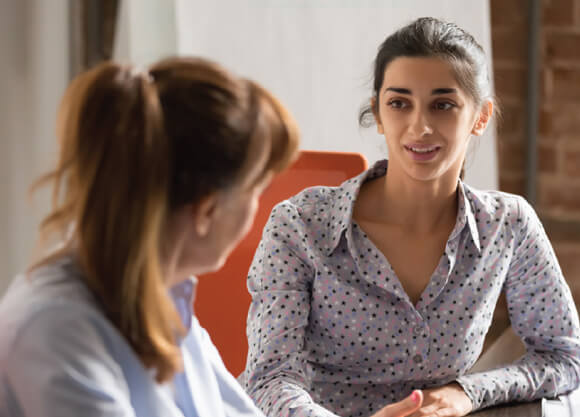 A mental health professional speaks with a student one-on-one